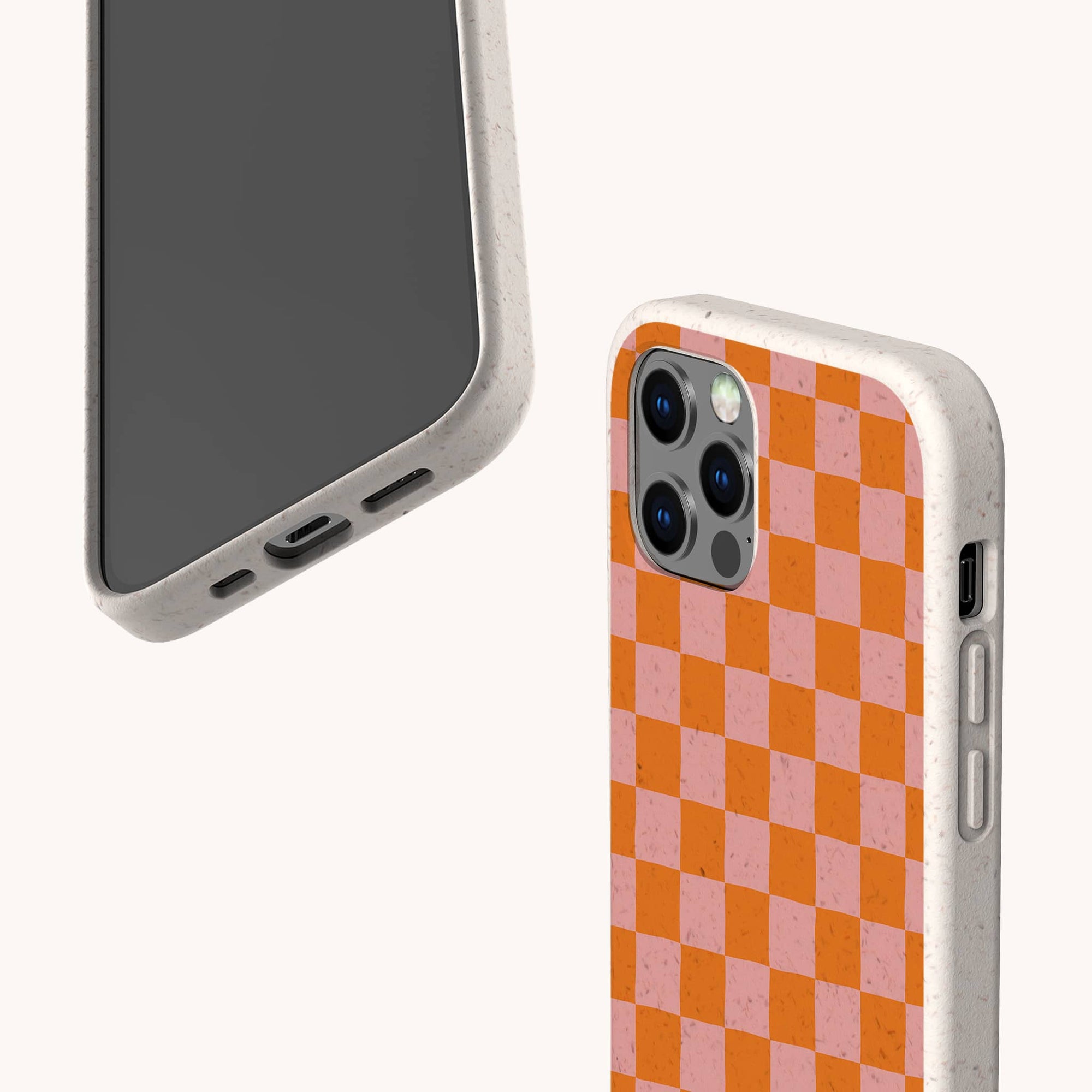 Two Orange Checker Eco-Friendly Phone Cases are displayed: one shows the blank front, the other reveals a bold orange and pink checkerboard back. Made from compostable materials, it's an eco-friendly phone case option.