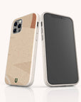 Two smartphones with beige, textured cases featuring a minimalist abstract design are displayed upright—one revealing the back of the case and the other showcasing the front screen—against a light background. The Abstract Strokes Eco-Friendly Biodegradable Phone Case effortlessly combines sustainability with modern style, making it an ideal choice for anyone seeking an abstract art phone case that is both contemporary and environmentally conscious.