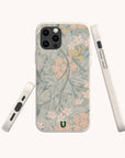 Introducing the Jasmine Eco-Friendly Phone Case—a sustainable phone case adorned with a soft floral pattern in pastel hues. The design features pink and yellow flowers accented by green leaves on a light background. The Jasmine Eco-Friendly Phone Case is displayed from three different angles.