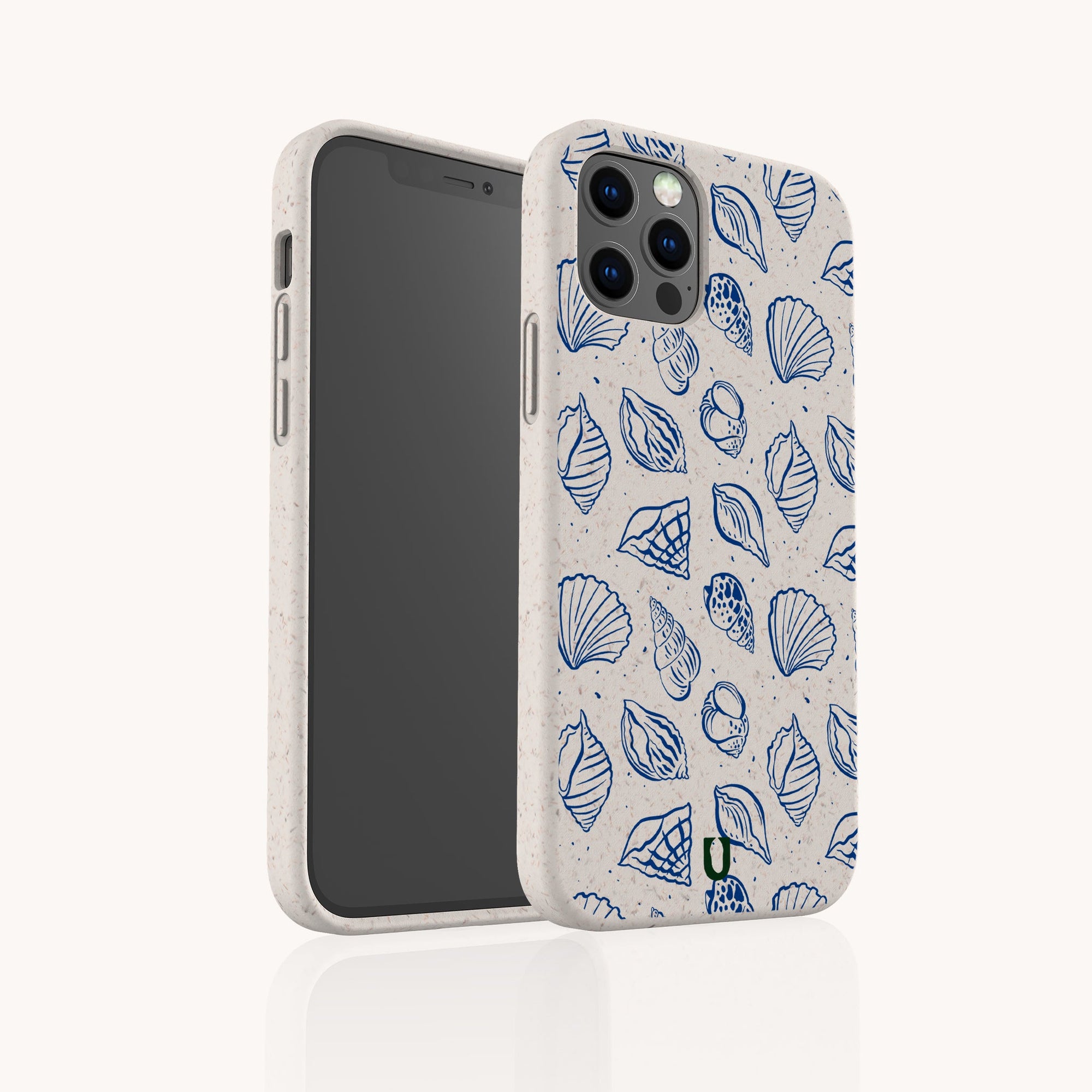 The Sea Shells Eco-Friendly Phone Case, shown for iPhone and Galaxy in beige with a blue seashell design, is displayed upright—one case faces front, the other shows the screen—set against a plain white background.