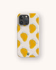 The Mangoes Eco-Friendly Biodegradable Phone Case showcases a repeating pattern of yellow mangoes with blue and white accents on a white background, and features a small dark green U logo at the bottom center.