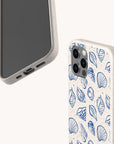 Two smartphones in speckled beige Sea Shells Eco-Friendly Phone Cases are displayed from various angles to showcase the eco-friendly texture; one case highlights a blue seashell pattern.