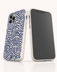 Two smartphones with white, biodegradable Ocean Waves Eco-Friendly Phone Cases featuring a blue, wavy line pattern reminiscent of ocean waves. One phone displays its screen, while the other showcases the stylish Ocean Waves Eco-Friendly Phone Case design on the back and camera area. Both devices stand upright on a white surface, emphasizing their sustainable and eco-friendly appeal.