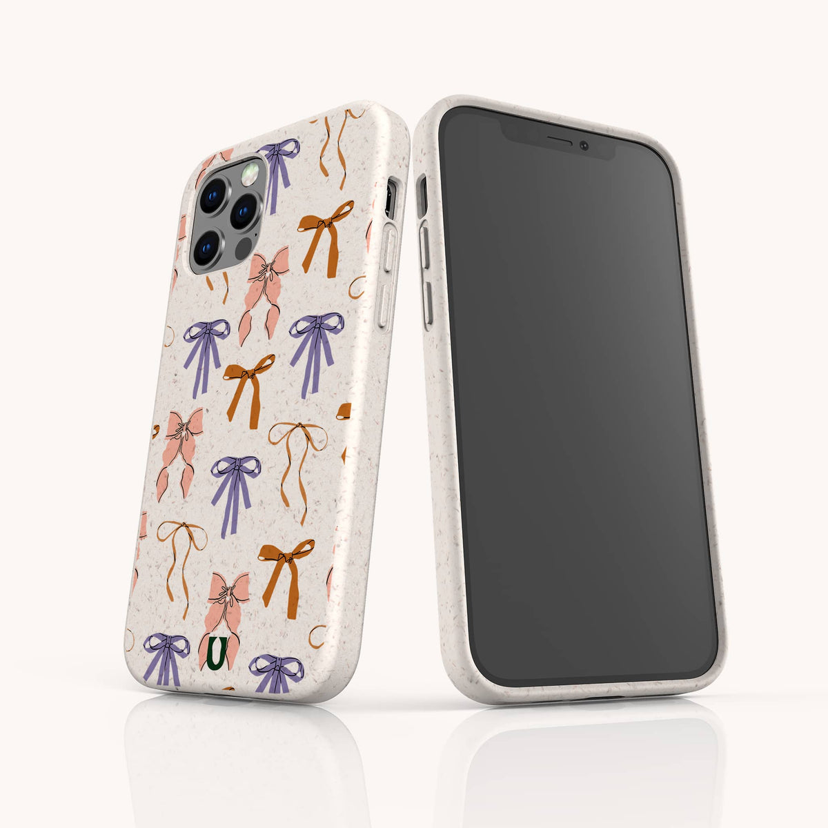 Two smartphones display the Bows Eco-Friendly Biodegradable Phone Case, decorated in white with a vibrant pattern of pink, orange, purple, and green bows. One phone showcases the screen, while the other highlights the eco-friendly case’s colorful back design.