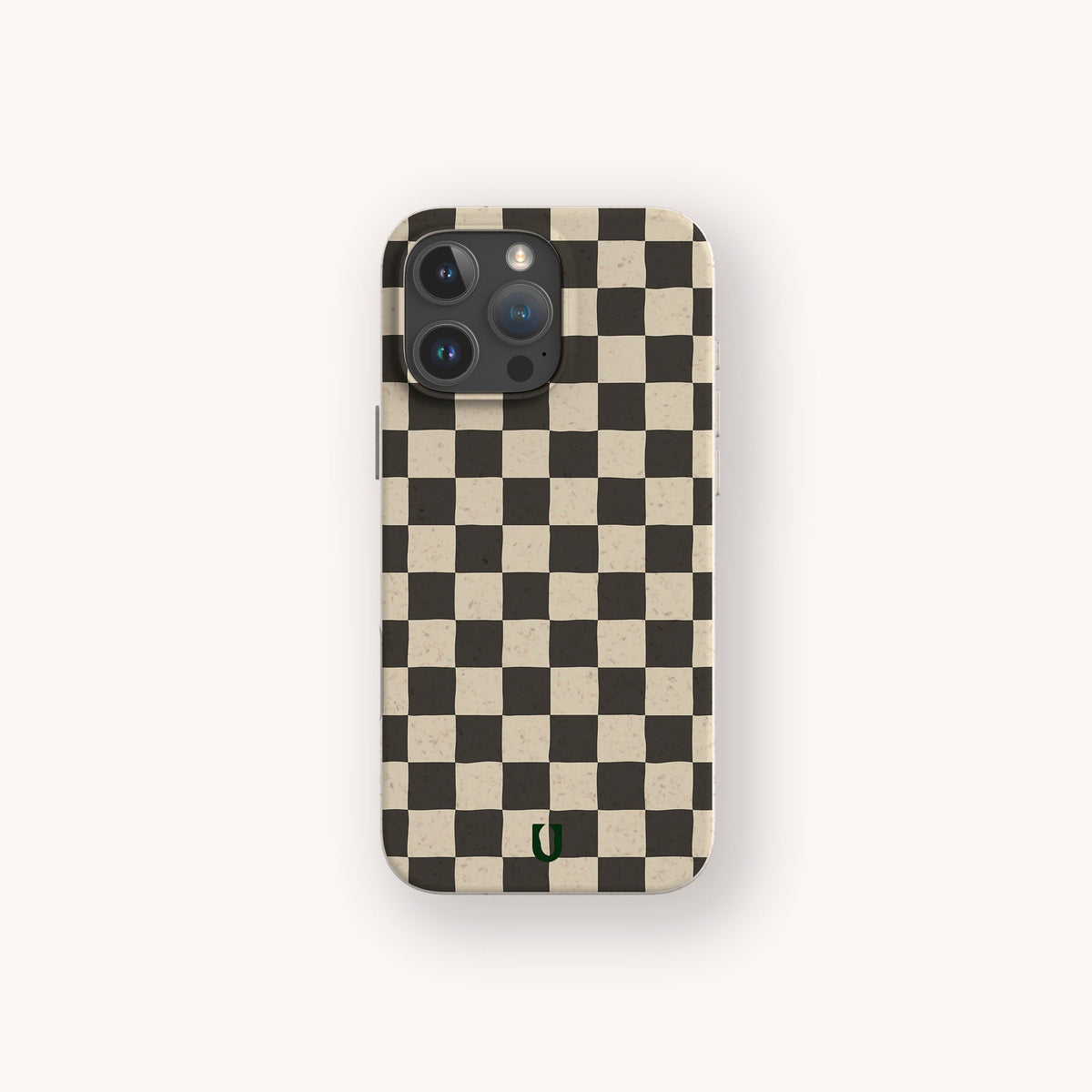 A Black Checker Eco-Friendly Phone Case, showcasing a classic black and white checkerboard design, is displayed on a light background. The phone’s camera lenses are visible at the top left, and a small green logo appears near the bottom of this eco-friendly case.