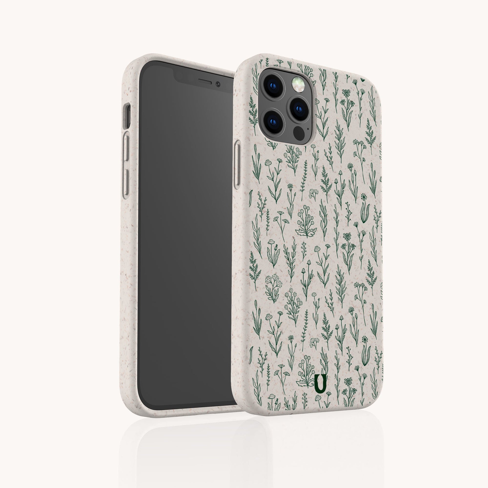 The Green Wild Flowers Eco-Friendly Phone Case is biodegradable, features a beige background with a green botanical pattern and a small green horseshoe logo, and fits iPhone and Samsung Galaxy models.