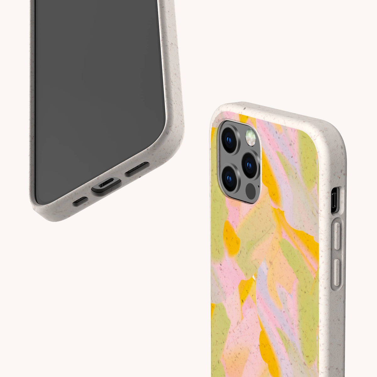 Two smartphones are shown in pastel-toned, speckled cases. One displays the front and side ports, while the other reveals the back with a soft abstract pattern featuring pink, yellow, green, and orange shades. These are Peach Sorbet Eco-Friendly Phone Cases—biodegradable and compatible with both iPhone and Samsung devices—for effortless style and sustainability.