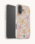 Two smartphones with the Starfish Eco-Friendly Biodegradable Phone Case in beige, featuring pink, orange, and yellow starfish patterns. One phone is displayed facing forward to show the screen, while the other reveals the back and camera design.