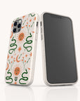 Two smartphones in The Sun and the Moon Eco-Friendly Phone Cases, featuring vibrant white eco-friendly designs with colorful celestial motifs—orange suns, green snakes, stars, moons, and horseshoes. One phone displays the striking back design, while the other shows a plain black screen.