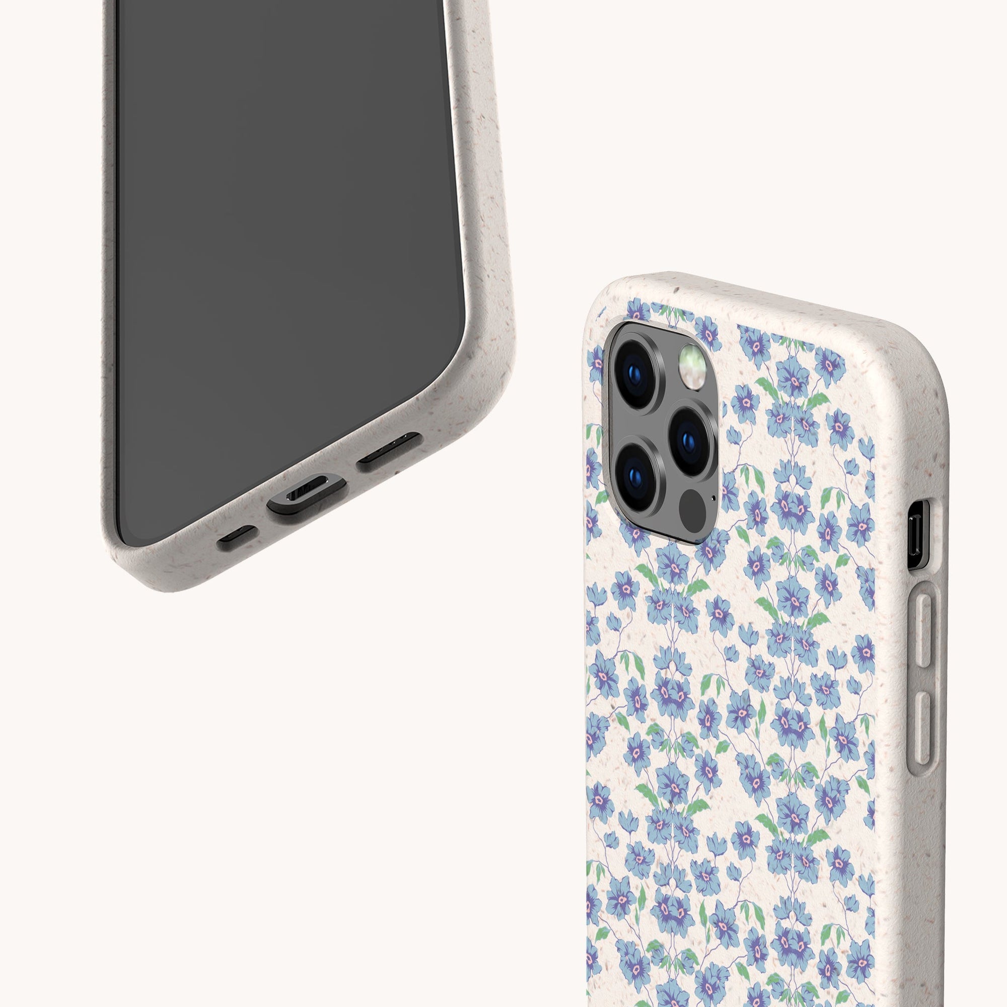 Two smartphones are shown: one displays its screen, while the other features a Blue Ditsy Flowers Eco-Friendly Biodegradable Phone Case in a charming blue and purple floral pattern.
