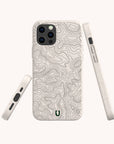 Three views of the Terrain Lines Eco-Friendly Phone Case, featuring a beige topographic map design and displaying the back, side, and bottom. The back showcases precise cutouts for the camera alongside a small green horseshoe-shaped logo. This compostable case is crafted to protect your device while reducing environmental impact.