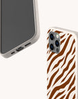 Two smartphones in beige speckled cases; one reveals the screen, while the other showcases the Brown Zebra Eco-Friendly Phone Case’s bold brown and white zebra stripe pattern on the back. Both offer precise cutouts for buttons and ports, making these sustainable cases as fashionable as they are environmentally conscious.