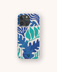 The Sea Bed Eco-Friendly Phone Case showcases bold blue and teal leaf patterns on a cream background, inspired by the ocean and crafted with sustainability in mind, shown against a light backdrop.