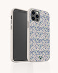 Two smartphones with the Blue Flowers and Bow Ribbons Eco-Friendly Biodegradable Phone Case rest on a cream background; the case features delicate blue bows, green leaves, and subtle blue flowers in its design. One phone is displayed facing forward to show the screen, while the other is angled to showcase the charming back design.