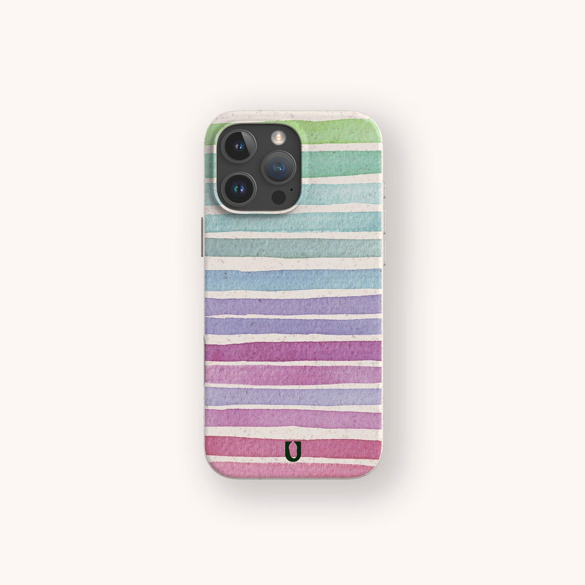 A smartphone with the Winter Rainbow Eco-Friendly Phone Case, which features horizontal watercolor stripes in green, blue, purple, and pink on an off-white background and a small black U-shaped symbol at the bottom.