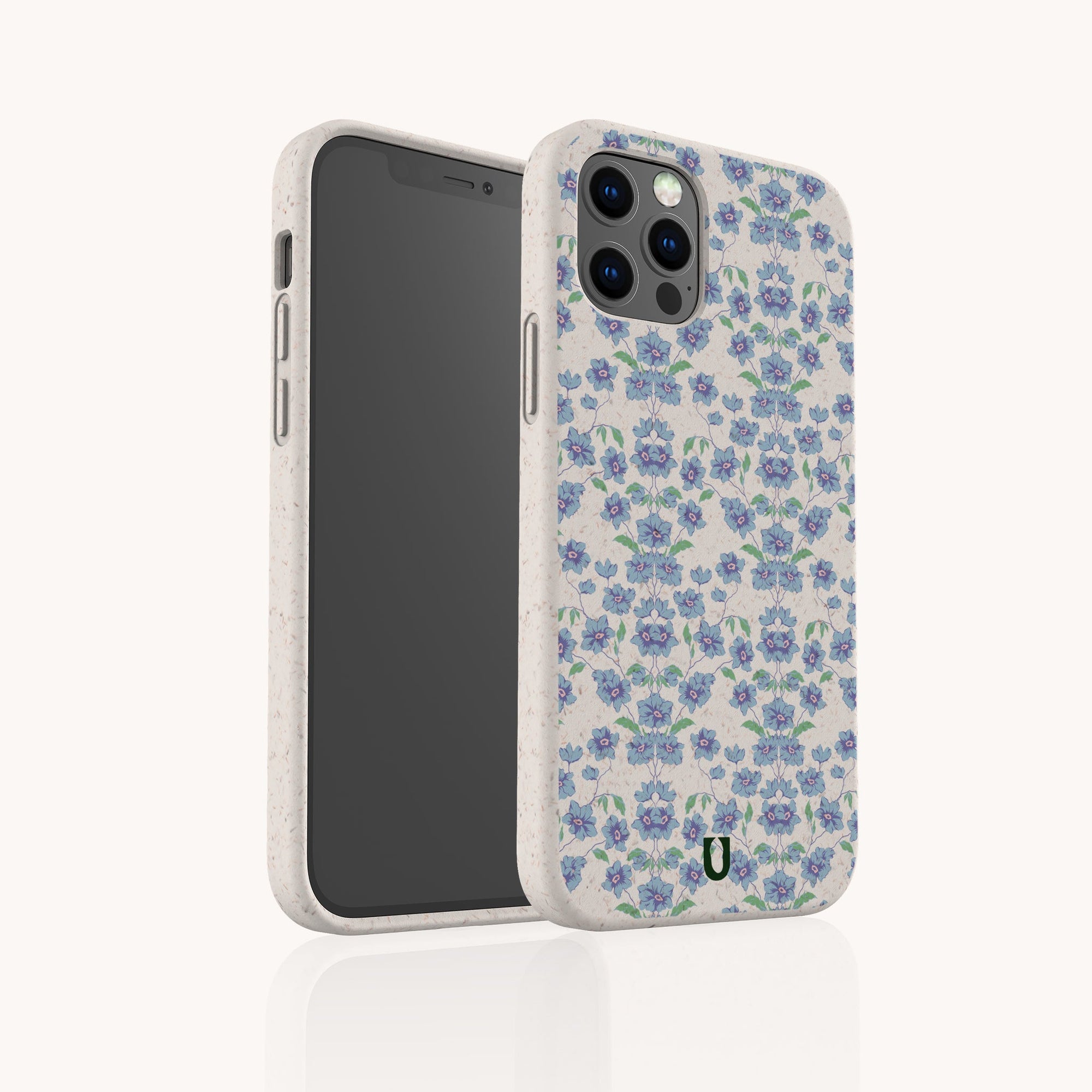The Blue Ditsy Flowers Eco-Friendly Biodegradable Phone Case features a blue and purple floral pattern on white, shown upright and at an angle to highlight its design and precise camera cutout.