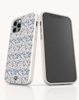 Two smartphones in white cases adorned with the Blue Flowers and Bow Ribbons Eco-Friendly Biodegradable Phone Case design, featuring a delicate blue floral tile pattern. One phone highlights the detailed back design, while the other displays its black screen facing forward. Both coquette phone cases are set against a plain white background, offering a charming and sustainable touch to your device.