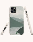 Introducing the Blue Watercolour Landscape Eco-Friendly Phone Case, featuring a minimalistic mountain and river design in soothing watercolour tones. Shown from front, side, and bottom angles against a light background, this biodegradable phone case perfectly blends style and sustainability.