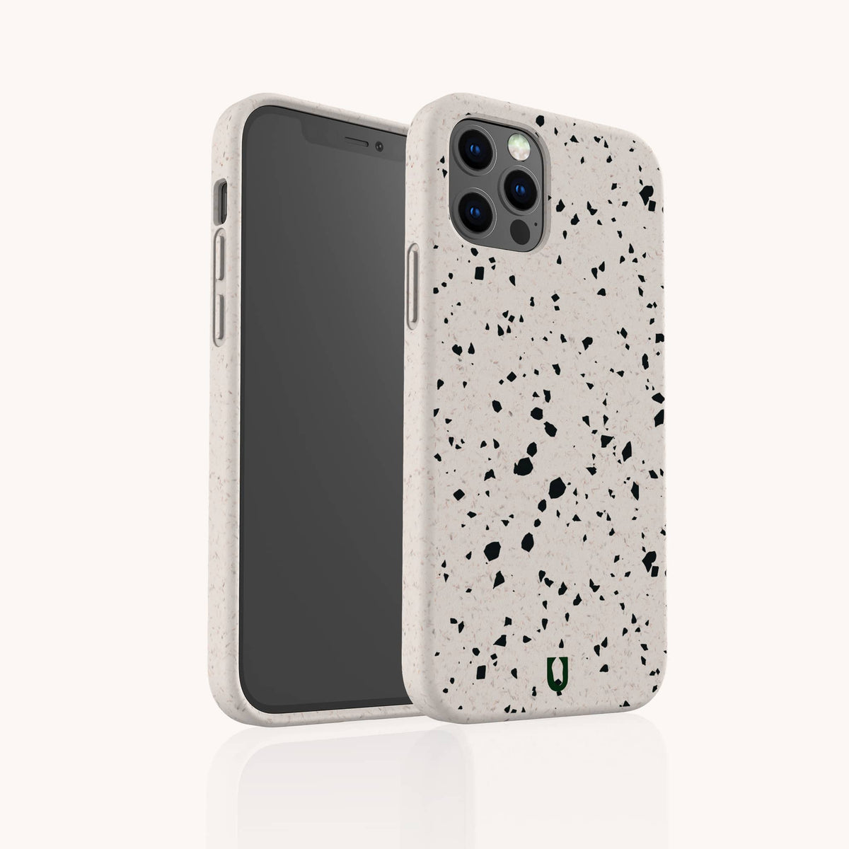 Two smartphones are pictured with the Black Terrazzo Eco-Friendly Phone Case in white, featuring a black speckled terrazzo pattern. One phone displays the screen while the other shows the back, highlighting the camera lenses and a small green logo at the bottom. This eco-conscious case combines a distinctive terrazzo design with sustainable materials for stylish protection.