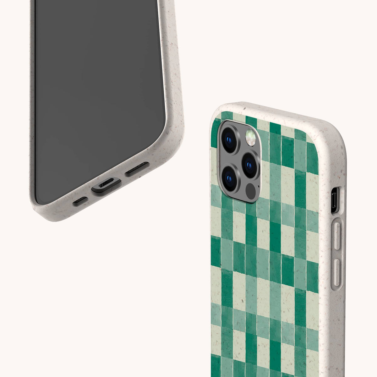 Two smartphones with speckled beige, eco-friendly phone cases—one featuring the Green Watercolour Checker pattern—are displayed floating against a plain light background. The biodegradable Green Watercolour Checker Eco-Friendly Phone Case fits both iPhone and Samsung Galaxy models and is shown from both the front and back.