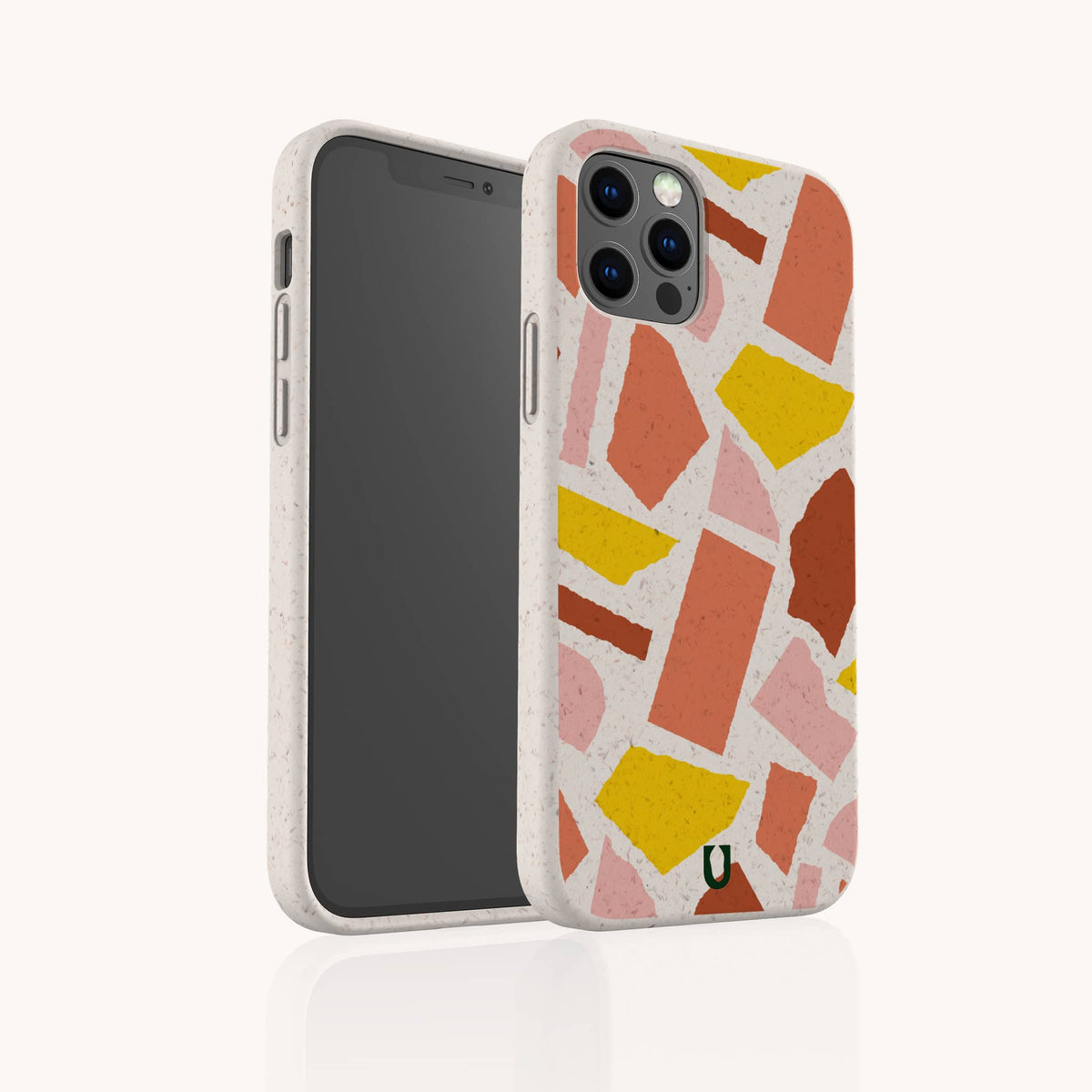 Two smartphones in white cases featuring the “Paper Scraps Eco-Friendly Biodegradable Phone Case” with a pink, yellow, and orange geometric pattern. One phone displays the screen, while the other showcases the back of the patterned biodegradable case, all set against a plain white background.