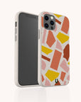Two smartphones in white cases featuring the “Paper Scraps Eco-Friendly Biodegradable Phone Case” with a pink, yellow, and orange geometric pattern. One phone displays the screen, while the other showcases the back of the patterned biodegradable case, all set against a plain white background.