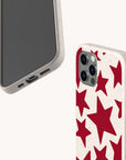 Two smartphones with beige, eco-friendly phone cases are displayed on a white background; one showcases the Burgundy Stars Eco-Friendly Biodegradable Phone Case featuring a bold pattern of large red stars, while the other reveals the plain, textured reverse side without any design. Both phones are partially visible.
